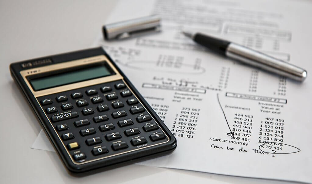 Calculator and pen over a financial document