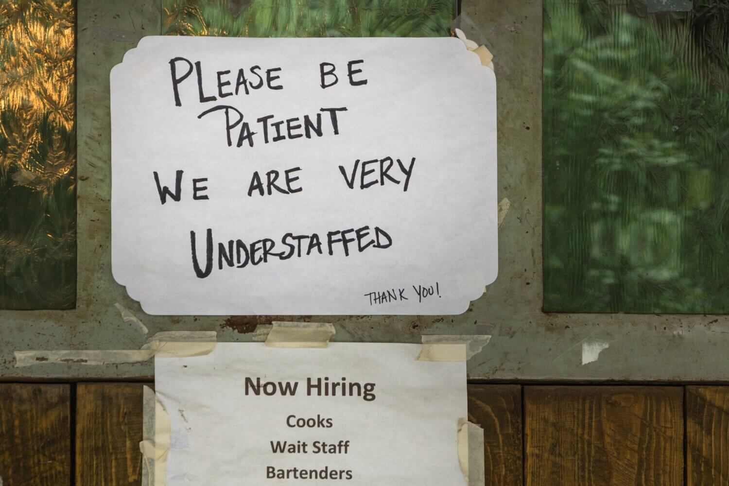 Hand-written sign saying "Please be patient we are very understaffed"
