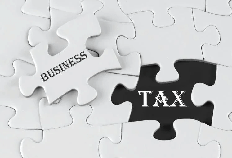 Jigsaw pieces saying "business" and "tax"