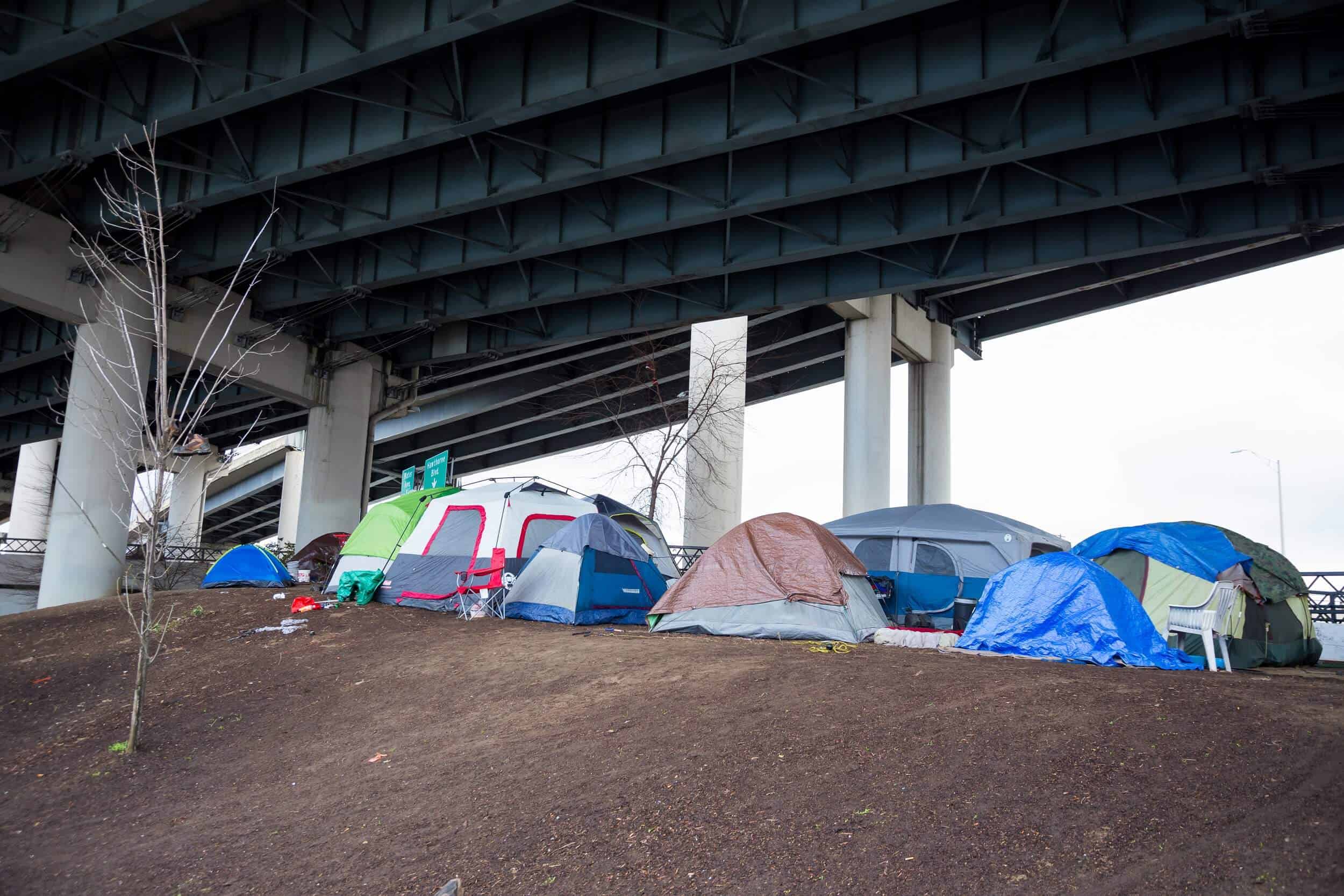 Homeless Tent Camp Portland Oregon Homeless camps with tents and tarp shelter under a bridge in downtown Portland Oregon.