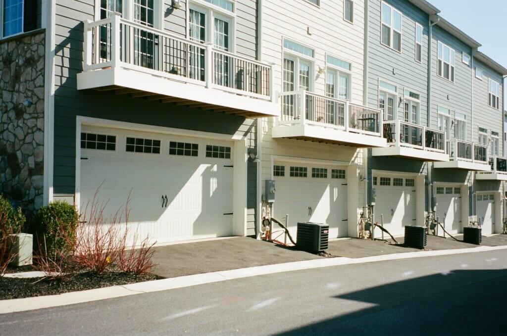 Modern Townhouses in a row with garages on ground level.